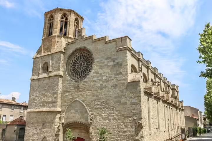 Gothic stone cathedral with rose window and bell tower in Carcassonne medieval city