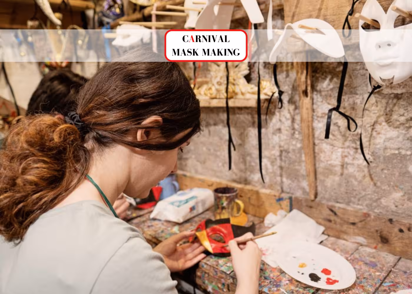 A woman paints a traditional carnival mask at a workshop in Prison's Palace, St Mark's Square, Venice.