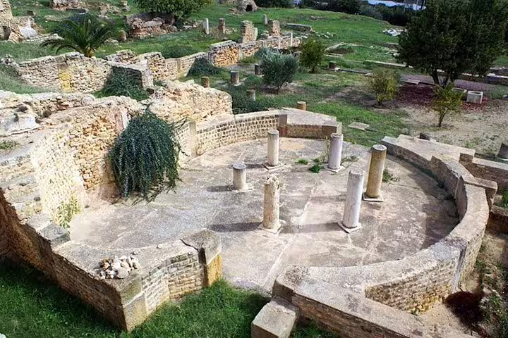 Visit the ancient ruins of Carthage, showcasing historical stone structures and columns amidst lush greenery on this half-day tour.