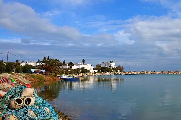 Scenic coastal view of Carthage with fishing nets and boats, perfect for a half-day tour exploring historic waterfronts.