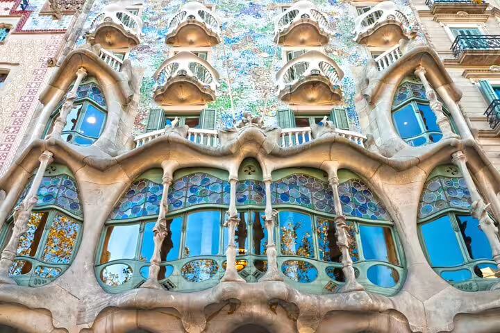 Casa Batlló facade with bone-like columns and colorful mosaic tiles by Antoni Gaudí in Barcelona