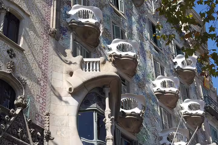 Casa Batlló’s ornate facade with unique balconies and mosaic details on the Private Casa Batlló & La Pedrera Tour.