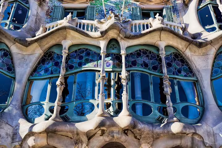 Close-up of Casa Batlló’s sculpted stone balconies and stained-glass windows seen on a Gaudí architecture tour in Barcelona