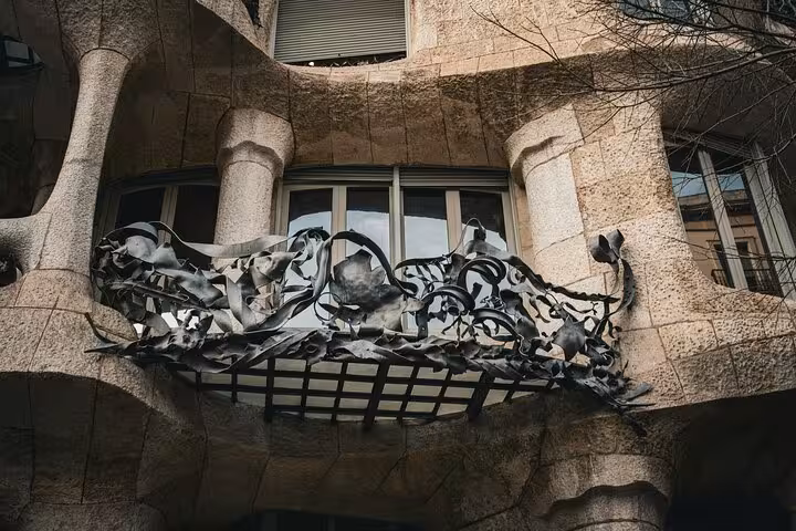 Experience the unique design of Casa Milà's intricate wrought-iron balcony on a private Barcelona city tour.