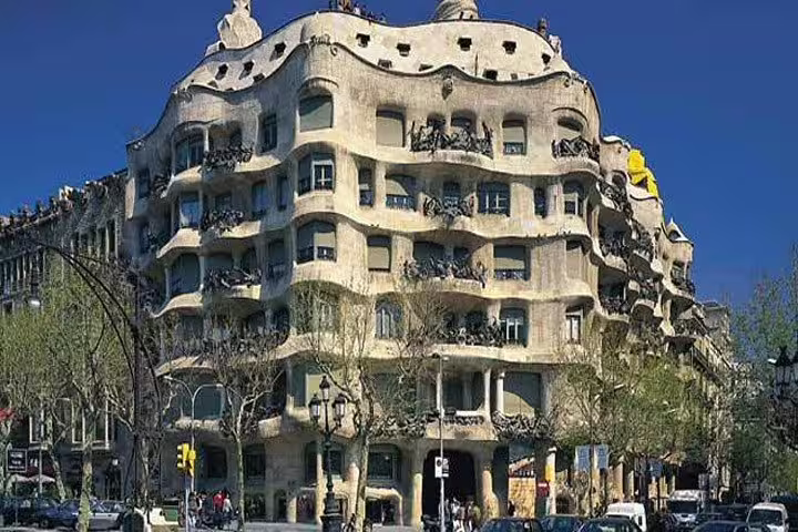 View of Casa Milà, a stunning example of Gaudí's architecture in Barcelona, under a clear blue sky.