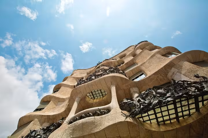 Low-angle view of Gaudí’s Casa Milà La Pedrera façade, key stop on Barcelona Modernism walking tour