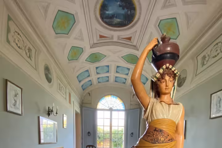 Vintage figurine centerpiece in Casa Museo NENA Bologna, showcasing historic decor on the guided house museum tour