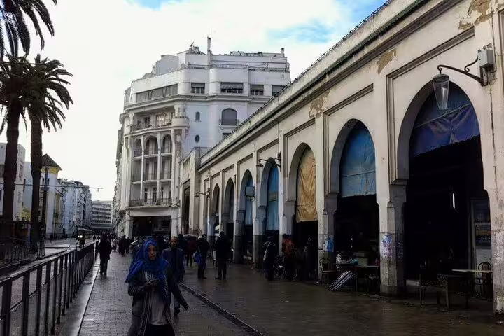 Casablanca old medina market street with arched arcades and local shoppers, featured on a private Casablanca day tour