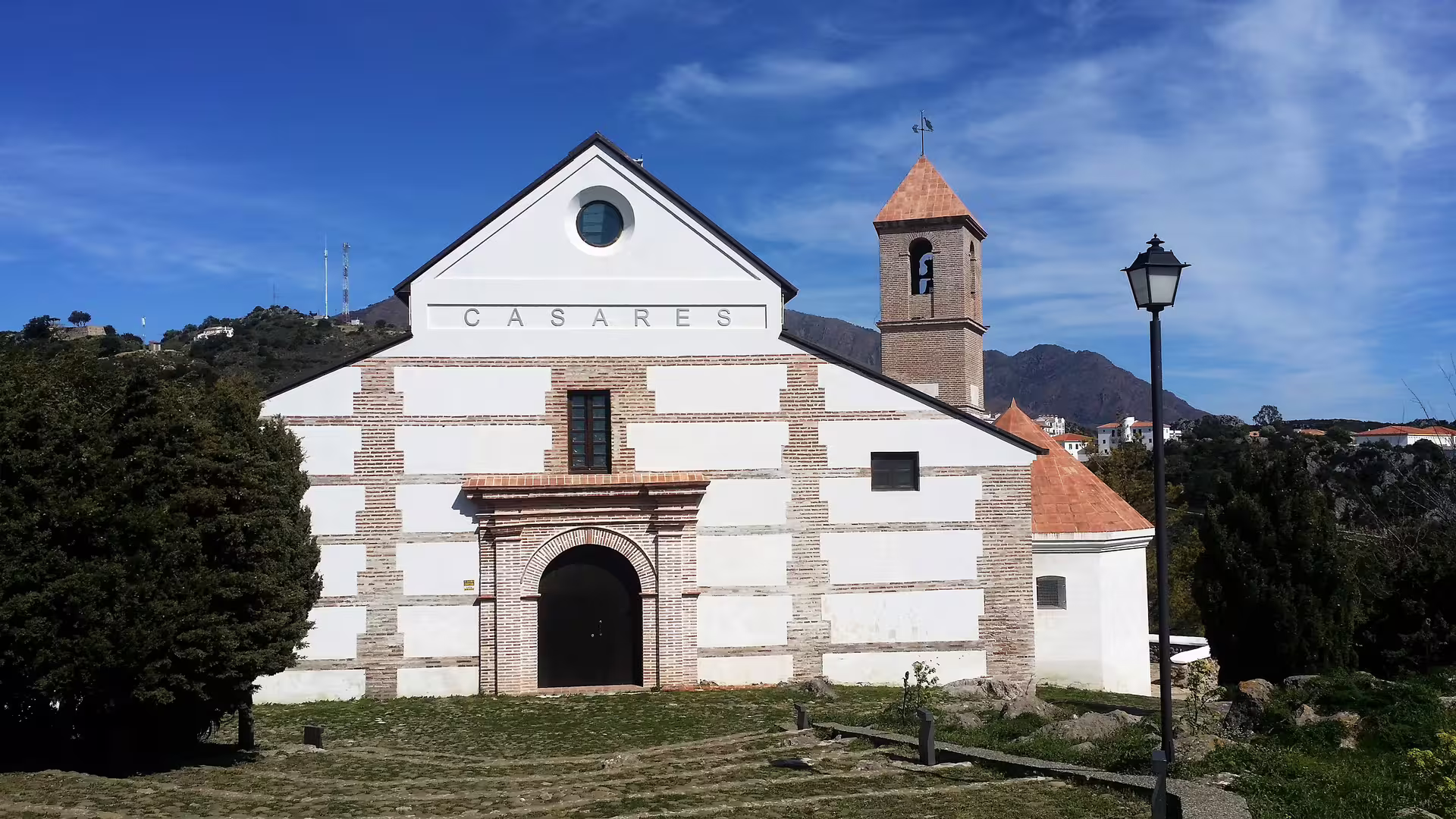 Casares church facade and bell tower with mountain views on a private tour from Costa del Sol