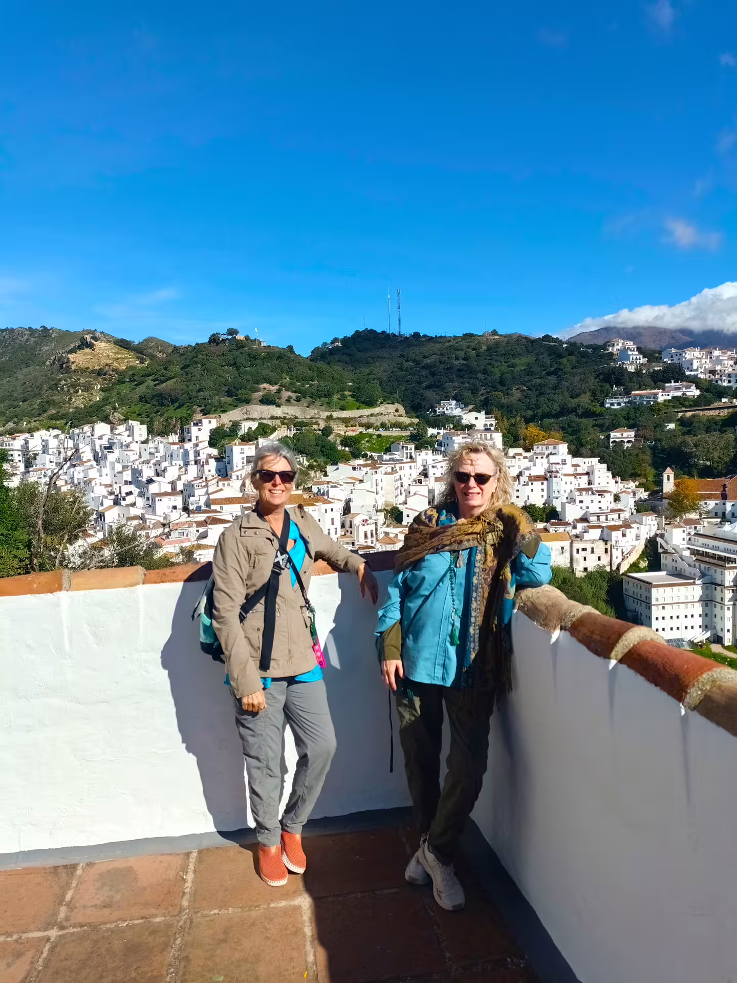 Travelers at Casares viewpoint on a private tour from Costa del Sol, overlooking the white village in Andalusia