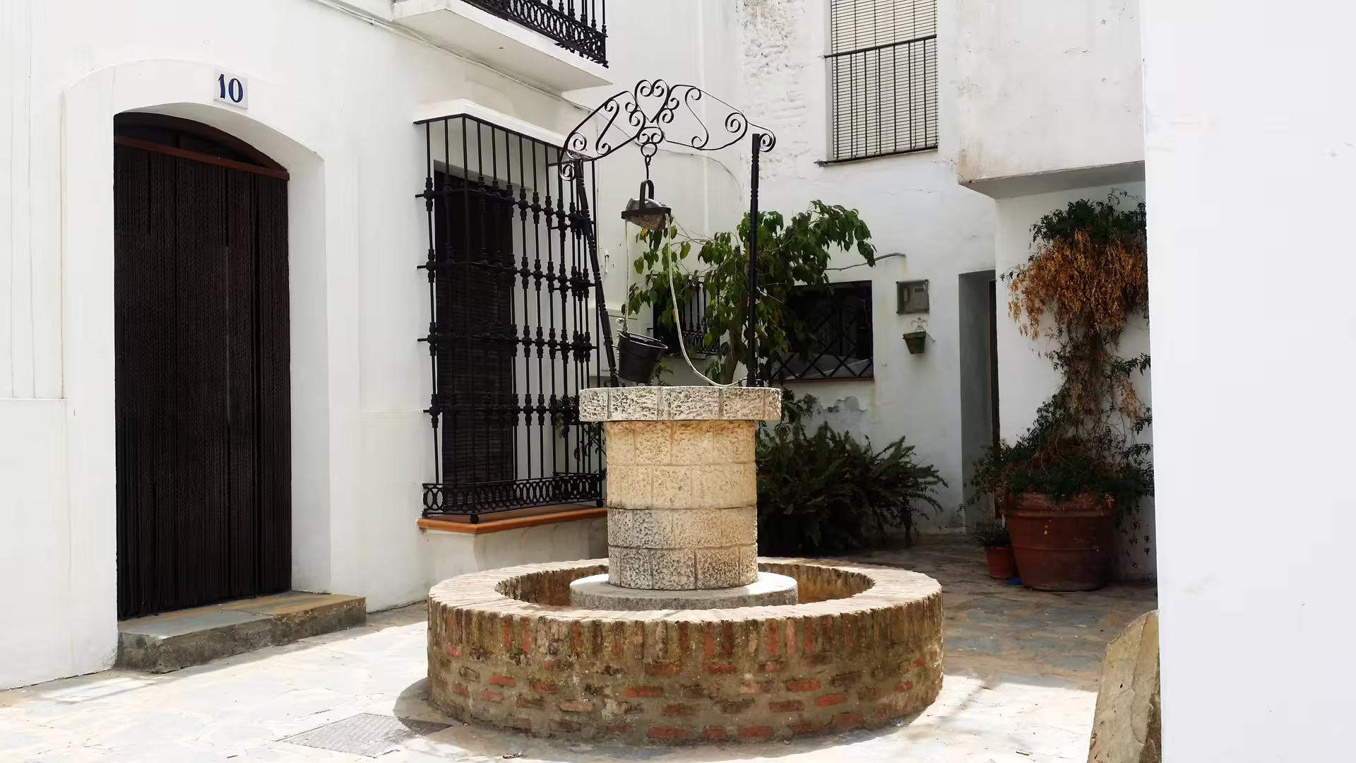 Traditional Casares courtyard well in whitewashed village on a private tour from Costa del Sol