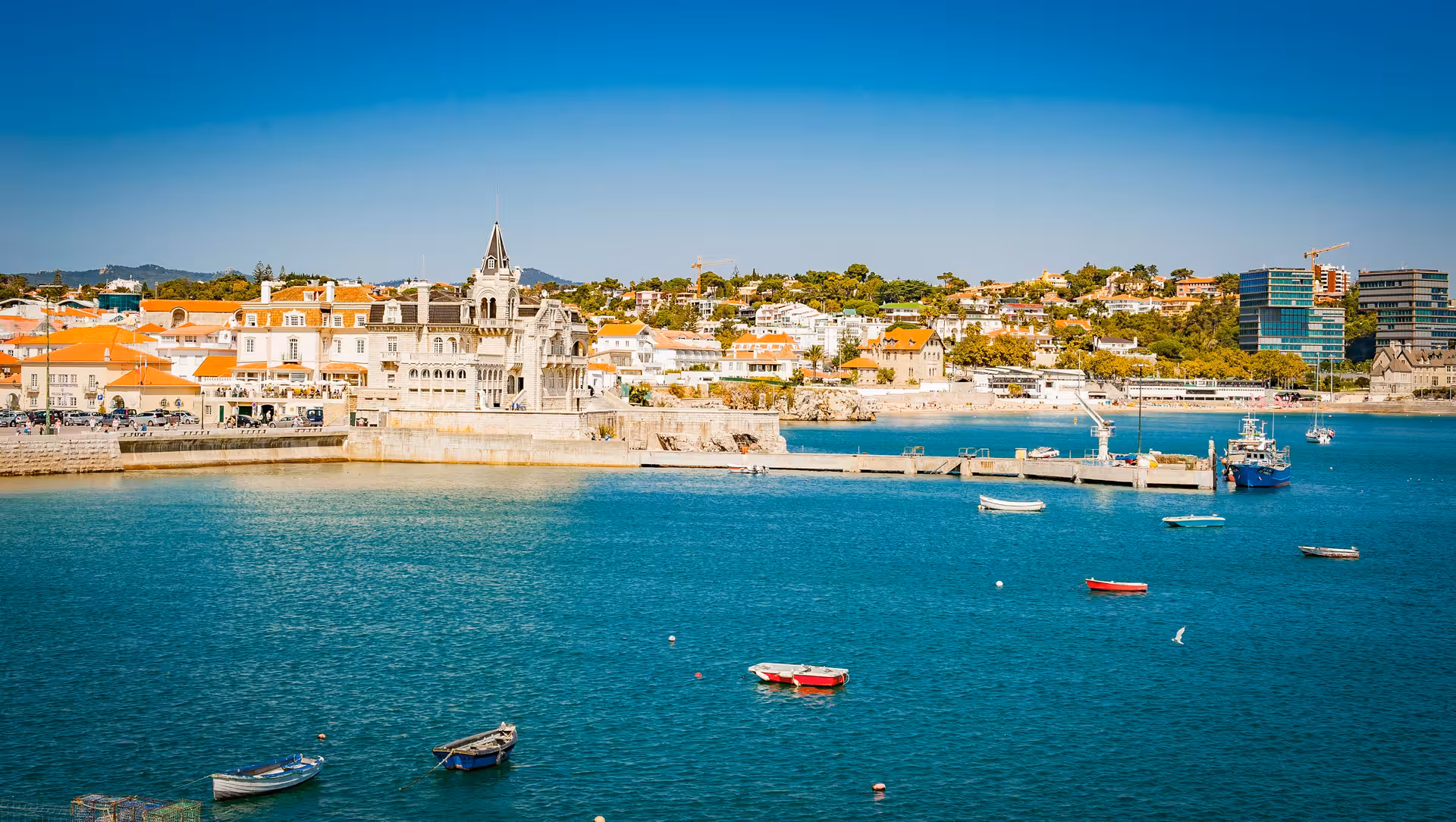 Scenic view of Cascais harbor with vibrant blue waters and historic architecture on the Sintra tour from Lisbon.