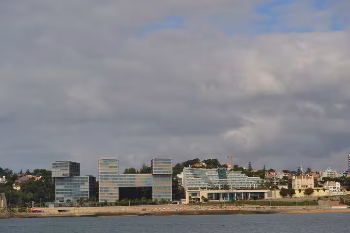 Modern Estoril-Cascais seafront skyline seen from a private 2-hour sailing cruise with onboard drinks
