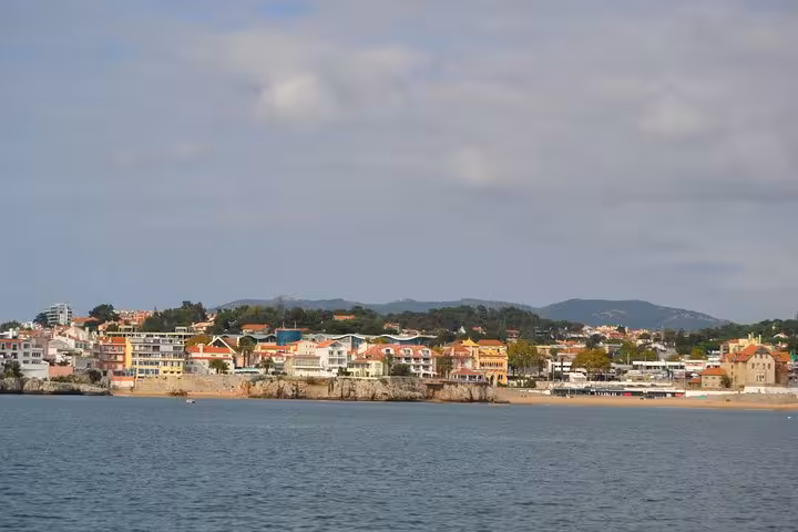 Coastal view of Cascais waterfront from a private sailing boat on a 2-hour cruise with drinks in Portugal