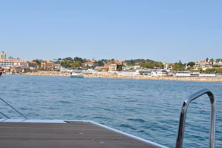 View of Cascais waterfront from a private sailing boat, calm Atlantic waters on a half-day or full-day cruise