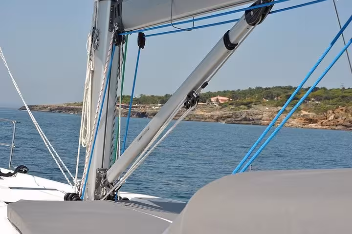 Sailing yacht deck and rigging on calm Atlantic waters near Cascais coast during private 2h cruise with drinks
