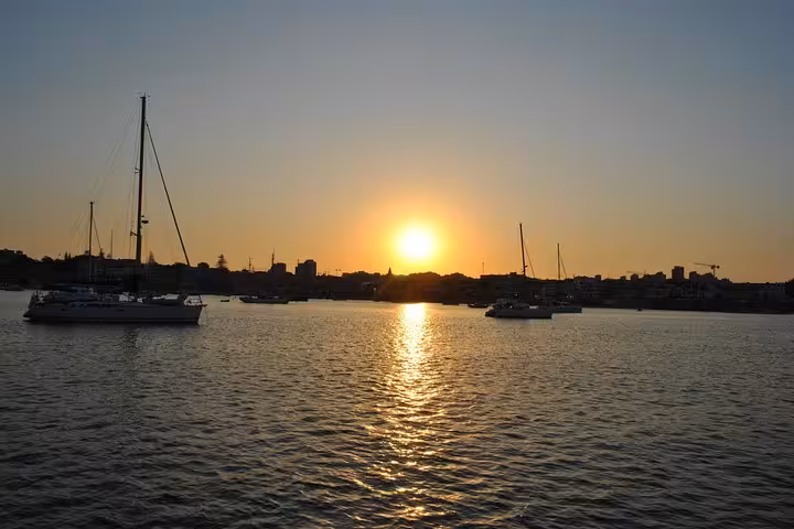 Golden sunset over Cascais marina with sailboats, ideal for a private 2h sunset cruise with drinks
