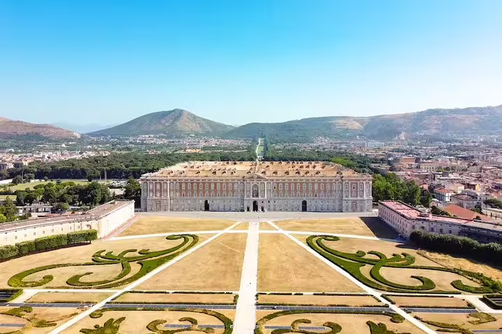 Aerial view of the Royal Palace of Caserta and formal gardens, highlighting the vast estate visited on small-group tours
