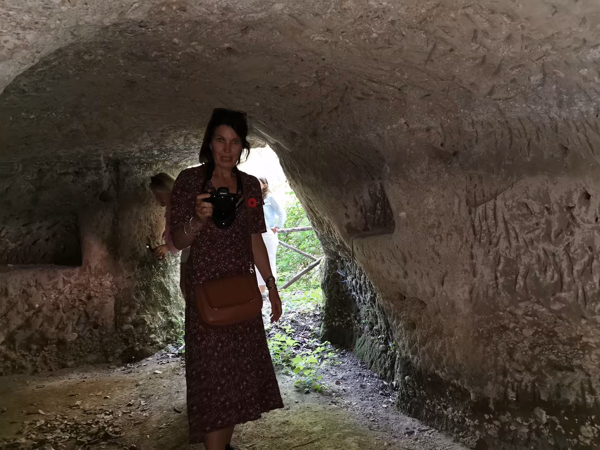 Visitor exploring an ancient cave on the Cassino Red Poppy tailor-made walking tour.