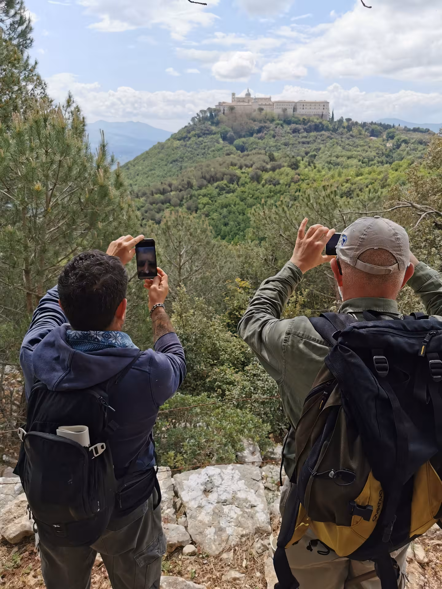 Tourists photographing the scenic Monte Cassino Abbey, showcasing the immersive walking tour experience.