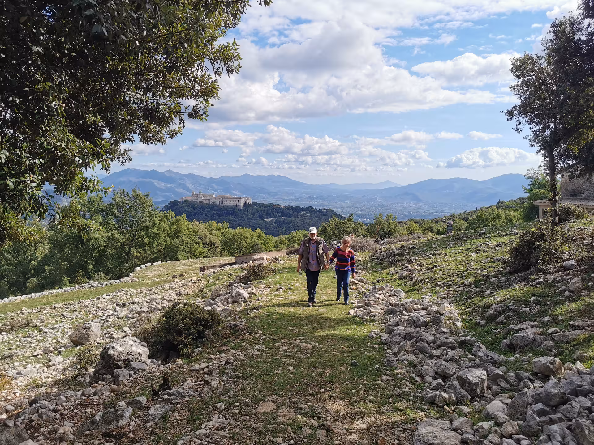 Scenic walk through Cassino's lush landscape with a view of the historic abbey in the distance.