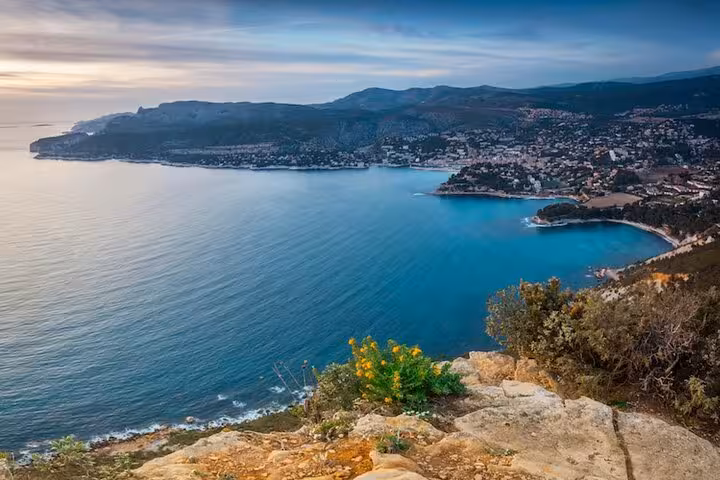 Breathtaking panoramic view of the Cassis coastline with the village nestled between azure waters and rolling hills.