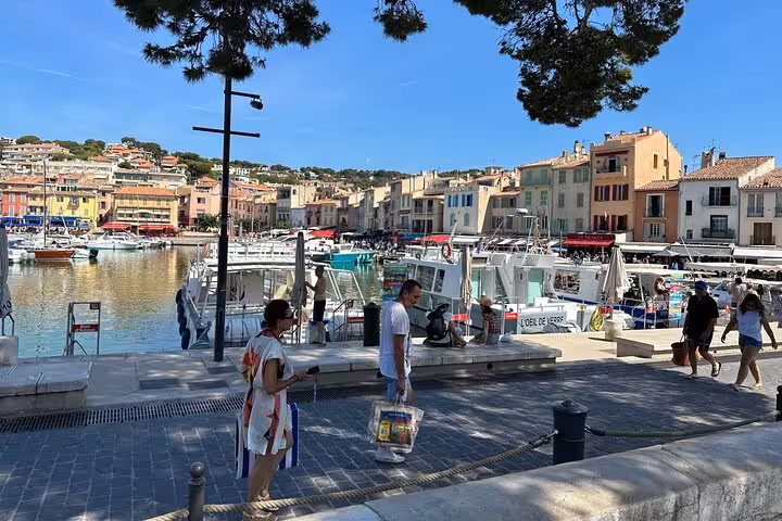 Cassis harbor waterfront with colorful houses and boats, stop on Aix-en-Provence, Cassis and Marseille day tour