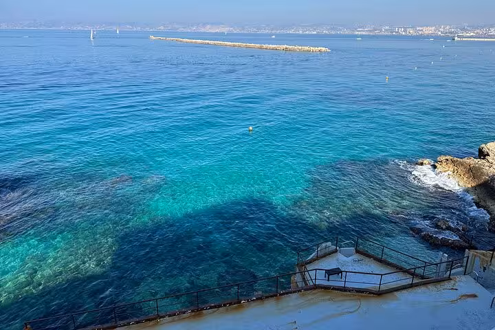Turquoise Mediterranean waters and rocky shoreline near Marseille on a private Cassis and city tour excursion