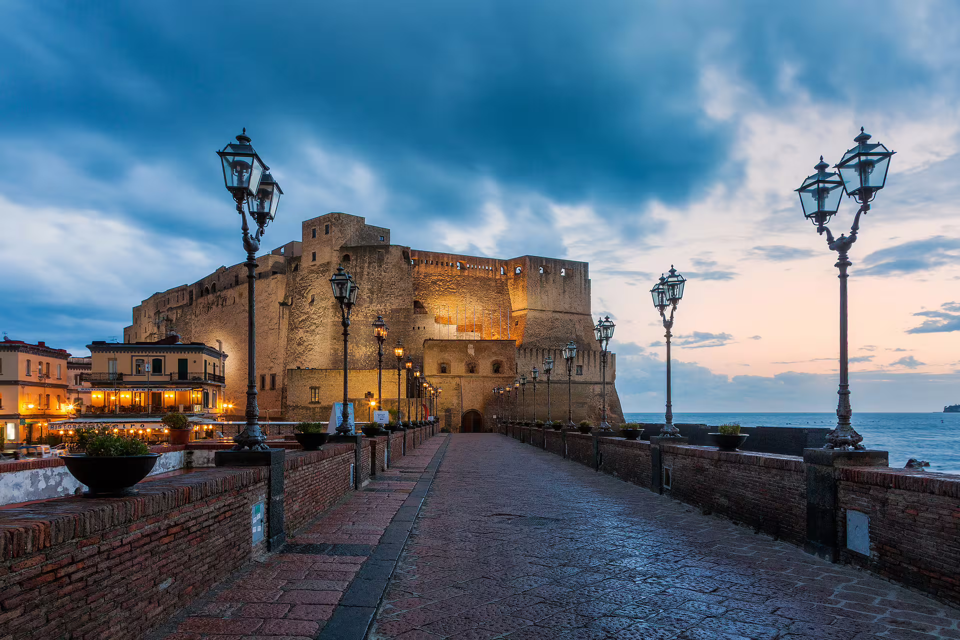 Castel dell’Ovo at dusk on Naples seafront, highlight of Naples Daylight walking and panoramic bus tour