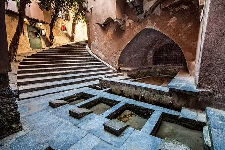 Medieval stone washhouse and stairway in historic Castelbuono visited on a private day trip from Palermo