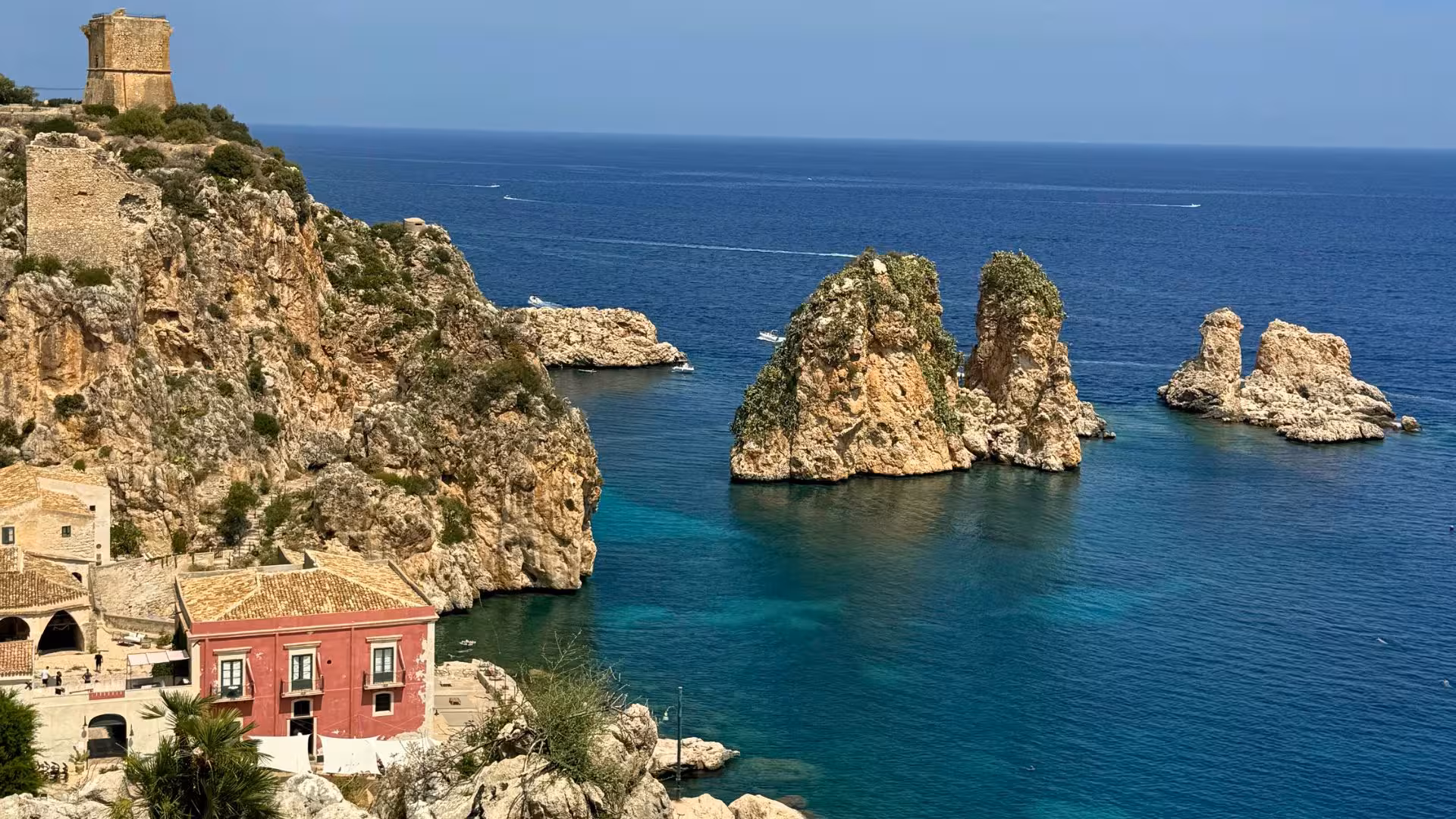 Scenic coastal view of Castellammare del Golfo with azure sea and rugged cliffs, ideal for an ebike tour.