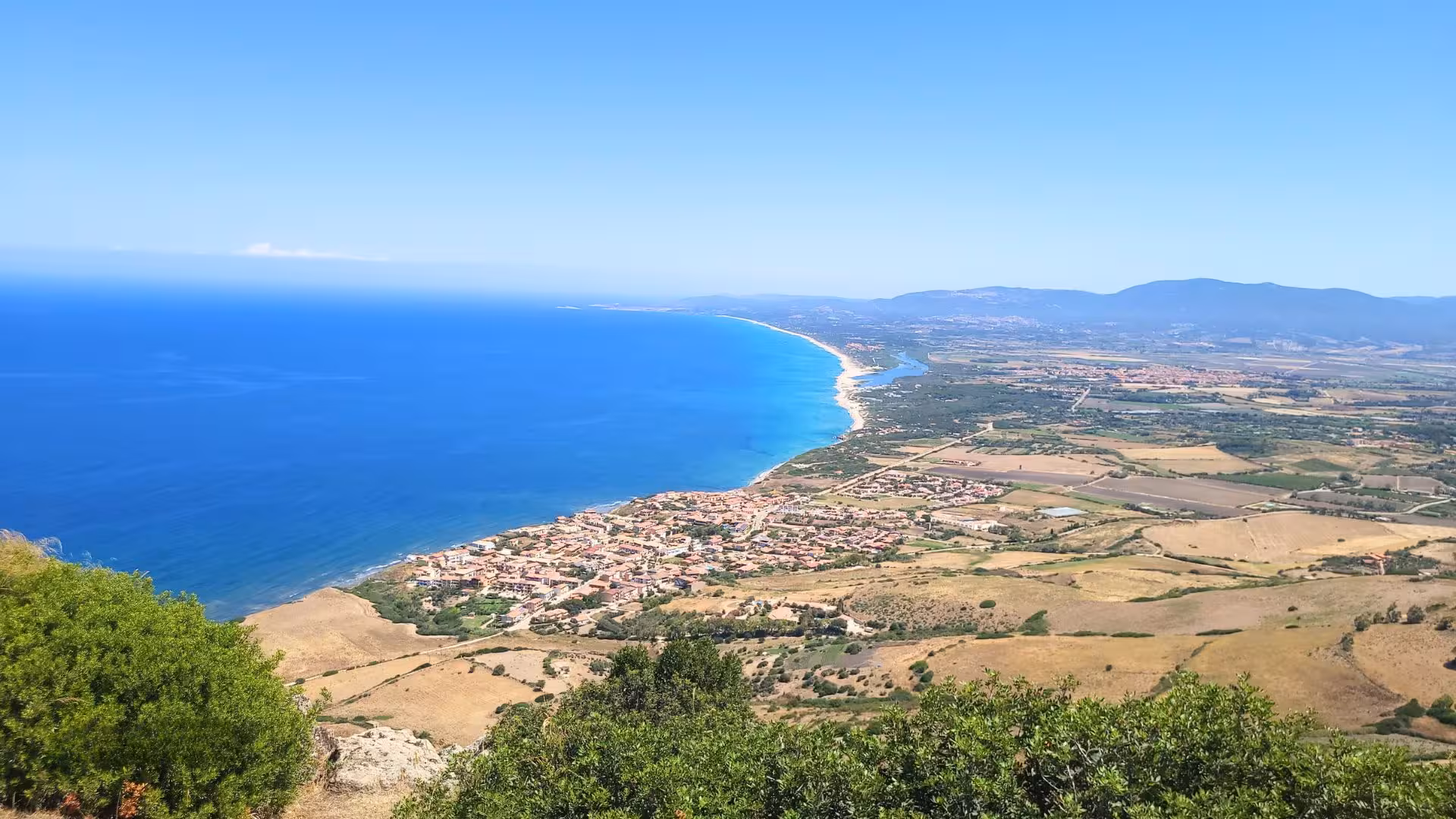 Breathtaking aerial view of Castelsardo's coastline with turquoise waters, ideal for adventure on an ebike tour.