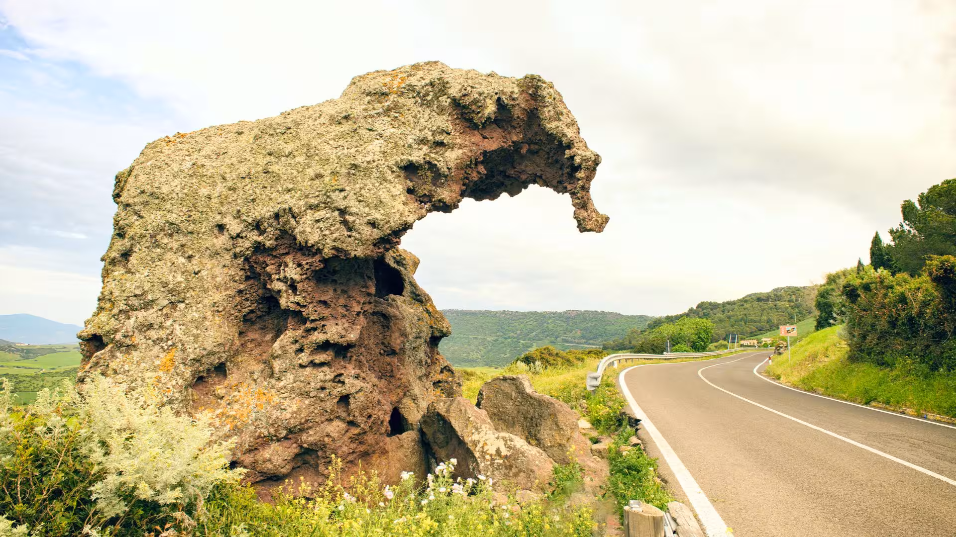 Unique rock formation along scenic road in Castelsardo, Sardinia, ideal for panoramic ebike tours.