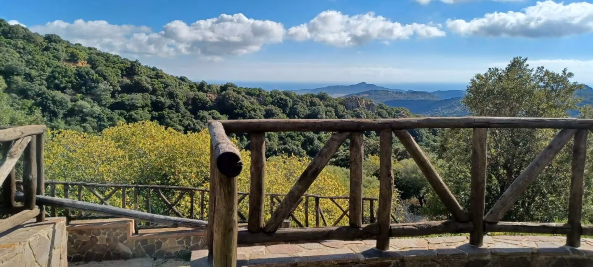 Scenic mountain view from a wooden terrace in S'Acqua Callenti, ideal for Castiadas trekking.