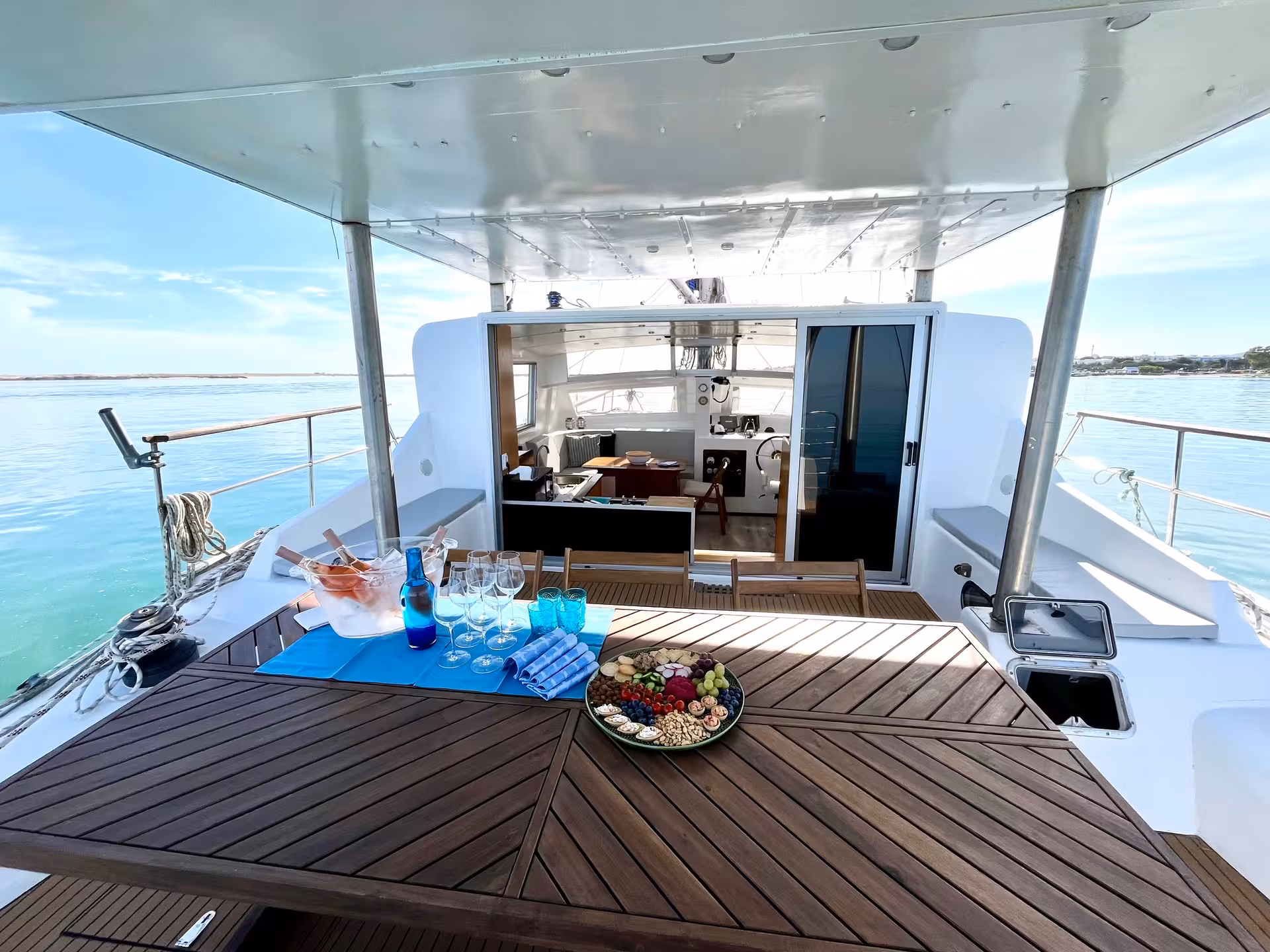 Catamaran deck set with welcome drinks and fruit platter on full-day Blue Lagoon sail tour in Malta