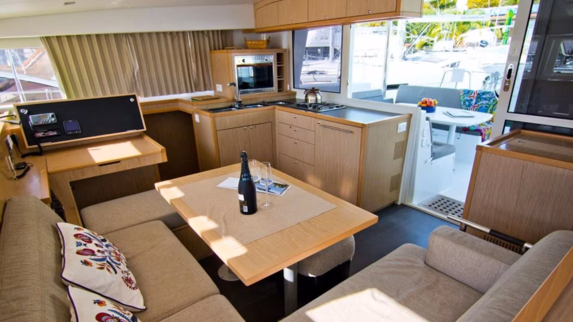 Spacious catamaran interior with modern kitchen and cozy seating, ideal for Tavolara Marine Protected Area tours.