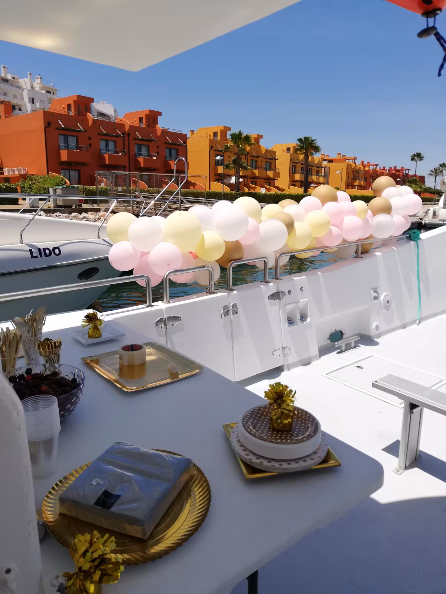 Decorated catamaran set for a private party cruise in Algarve marina, ideal for Benagil cave and Marinha Beach tours