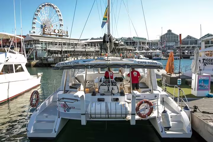Catamaran Serenity One docked at Cape Town's V&A Waterfront, perfect for sunset cruises and scenic views.