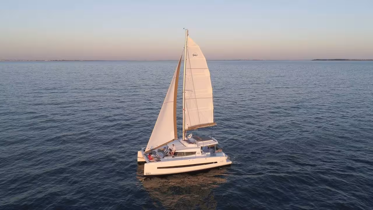 Sailing catamaran at sunset on Lagos Algarve coast, Portugal, perfect for a romantic sunset cruise tour