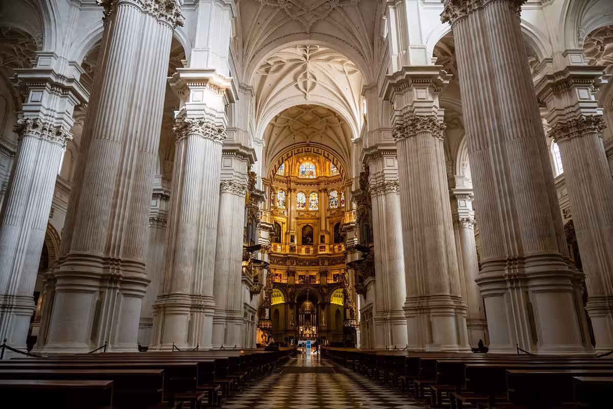 Majestic cathedral interior with towering columns and ornate stained glass on a guided tour with admission.