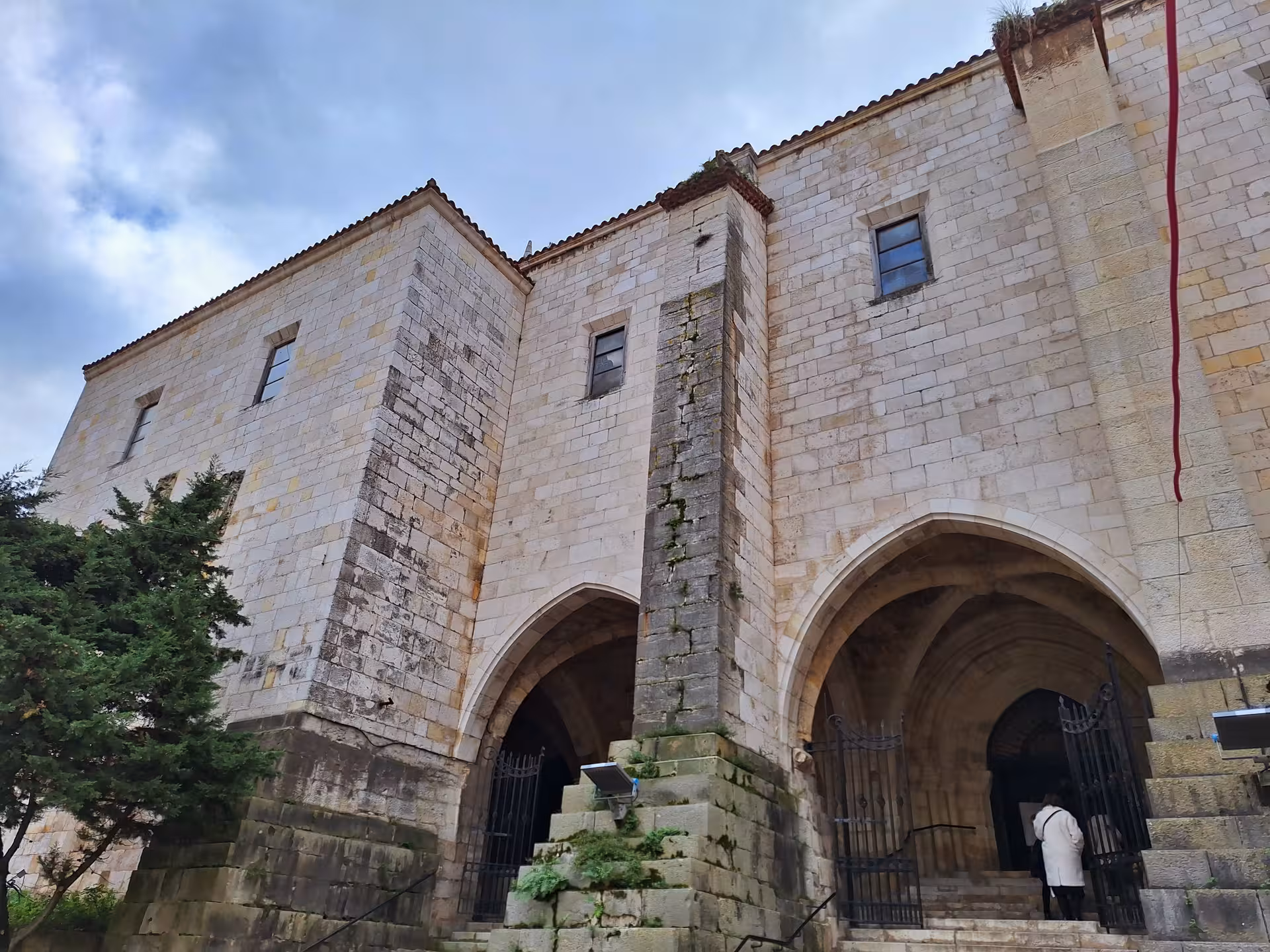 Explore the historic facade of the Cathedral of Santander on a guided tour, showcasing its grand arches and stone masonry.
