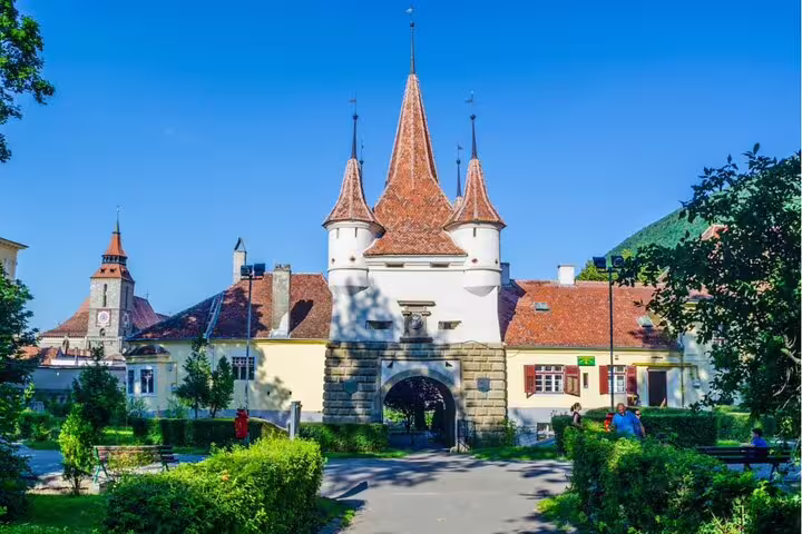 Catherine's Gate medieval fortress towers with white turrets and red rooftops in Brasov, Romania