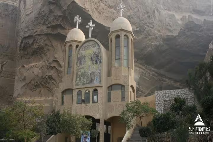 Cave Church Cairo façade carved into Mokattam cliffs, Coptic crosses and icon mural on guided tour