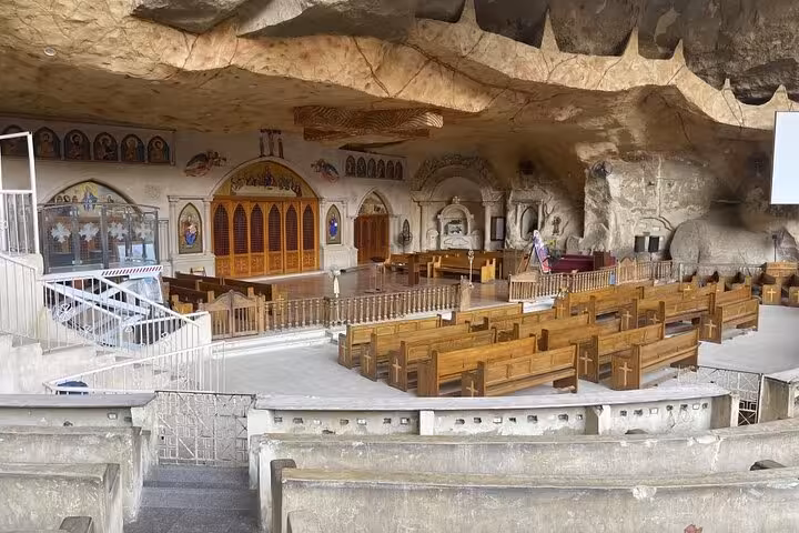 Cave Church of Saint Simon in Mokattam Cairo with wooden pews and carved rock sanctuary on guided tour