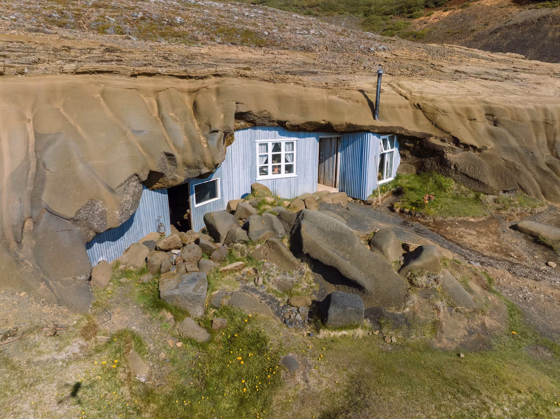 Unique cave house exterior nestled in rock formations, showcasing an adventurous standard cave tour destination.