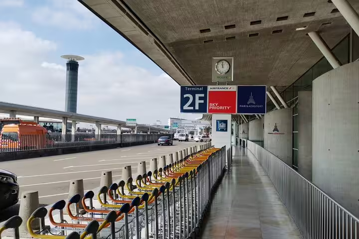Paris CDG Terminal 2F arrivals curbside pickup area for private transfer to central Paris hotels