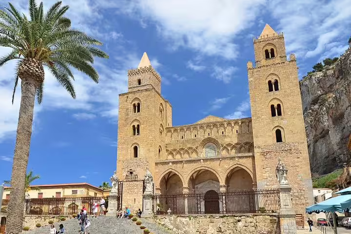 Tourists climbing steps to Cefalù Cathedral, a Norman seaside landmark on a private Palermo to Monreale and Bagheria tour