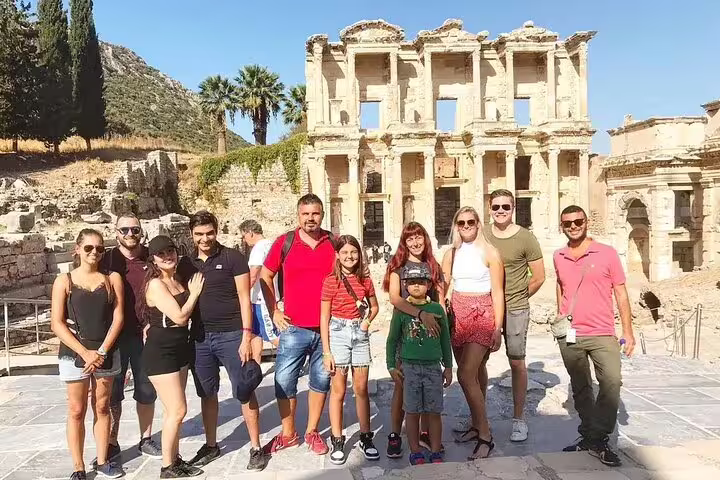 Visitors posing in front of the Celsus Library in Ephesus on a guided 2-day tour from Istanbul.
