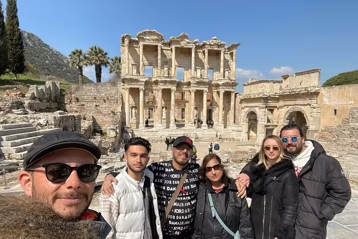Travelers enjoy a sunny day at the Celsus Library on the Ephesus private tour from Kusadasi Port.