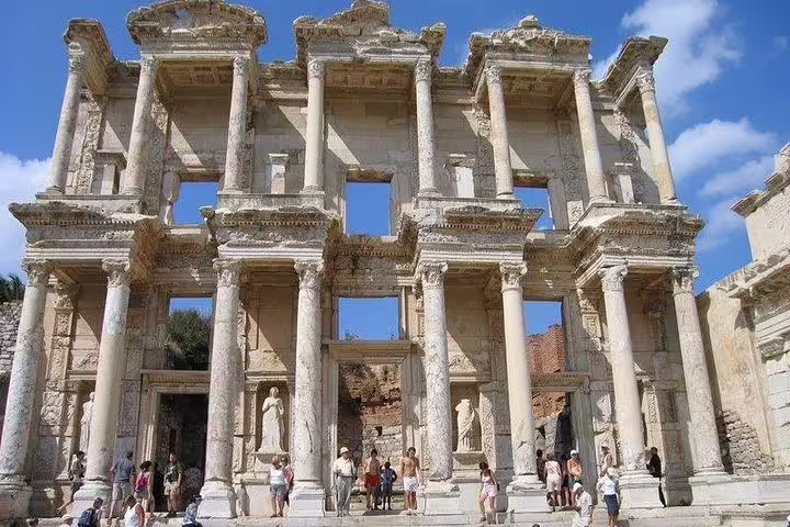 Celsus Library facade in Ephesus with visitors under blue sky, highlight of 10-day private Turkey tour